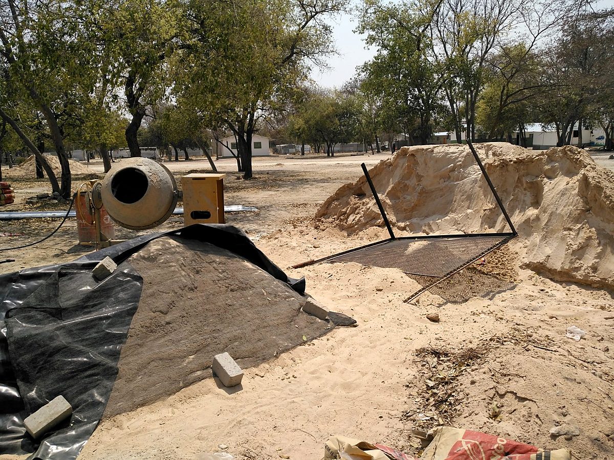 Concrete mixer and sand on site