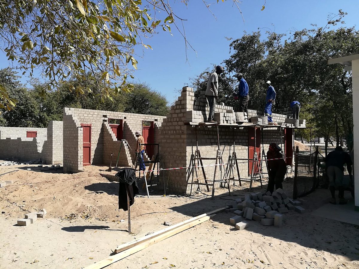 Walls rising on scaffolding at a Nofrica project