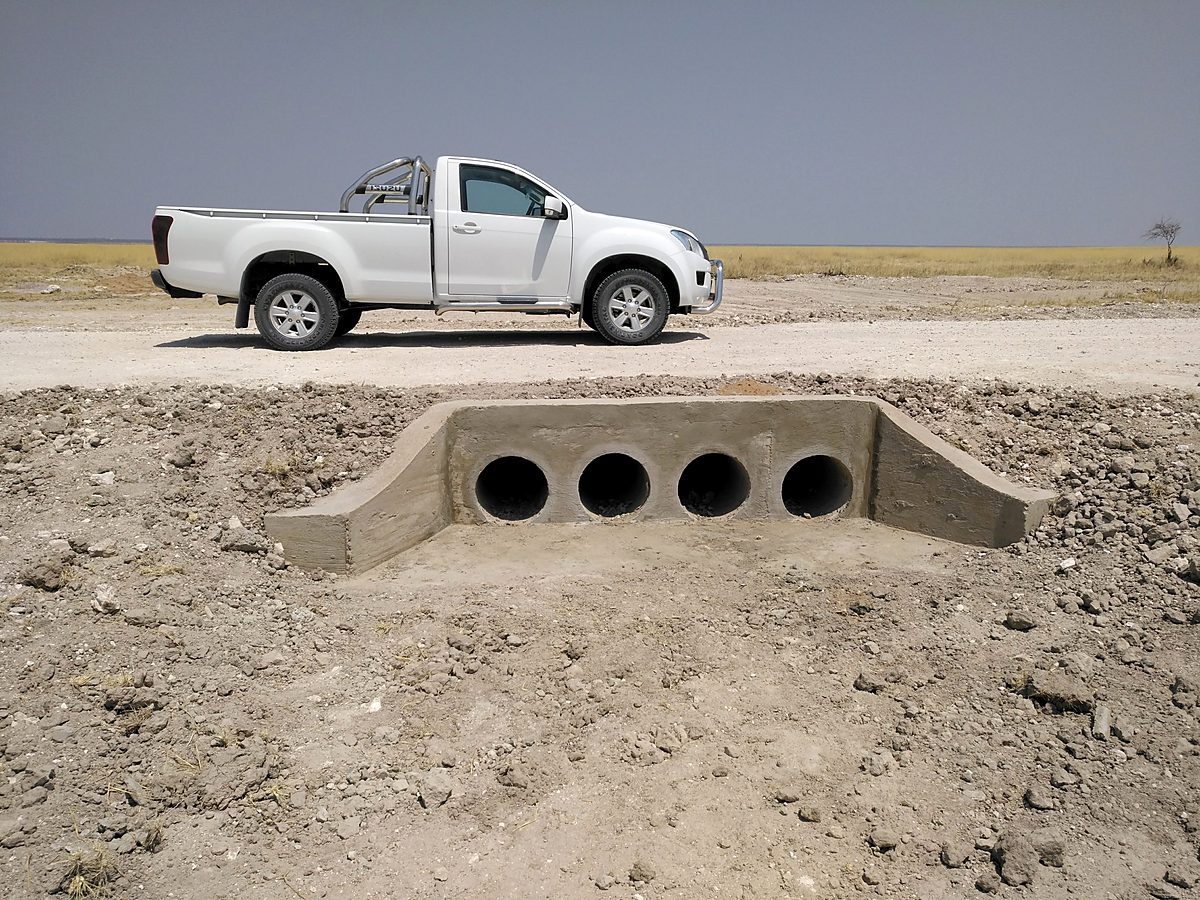 Four-cell concrete culvert built beside a gravel road